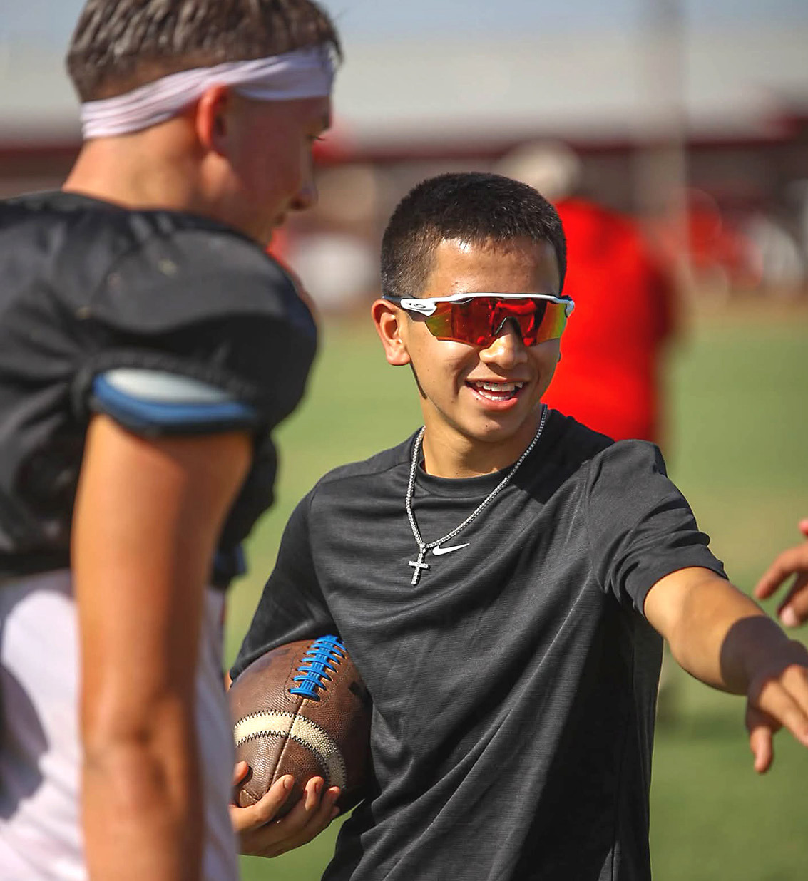 An A honor roll student, Wellington High School senior Dahmian Salinas greets his Skyrocket football teammates at practice and maintains his position of manager. Last February, Dahmian suffered a severe brain injury in a freak baseball accident. AUSTIN HARTSFIELD/SIDELINE SPORTS
