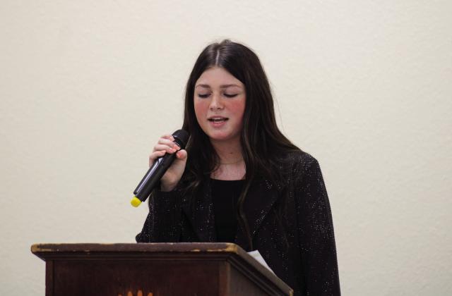 Quanah’s Lacy Teichroeb, daughter of John and Lena Teichroeb, performs at the Childress Rotary Club luncheon Thursday, Feb. 16 at Fair Park City Auditorium. Teichroeb performed “Dear Miss Loretta” by Carly Pierce, followed by a host of Loretta Lynn charttoppers, including “You’re Lookin’ At Country,” “They Don’t Make ‘em Like My Daddy,” “Fist City” and “Coal Miner’s Daughter.” The Red River Sun/Elizabeth Tanner
