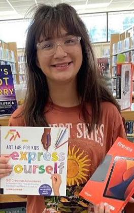 Wellington Junior High School eighth-grader Emma Zaragoza claims the teen Summer Reading Program prize, a brand-new Kindle Fire HD 8, to promote her love of reading even more. Collingsworth Public Library