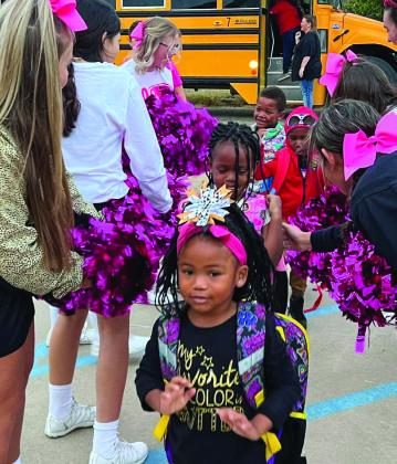 Cyclone cheerleaders greet Travis Elementary students