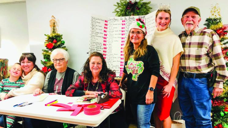 The Collingsworth County Chamber of Commerce Red Ticket Drawing Committee conducts the 2024 drawing at 4:30 p.m. Thursday, Dec. 19 in the Ellis Art Center of the Collingsworth County Museum. From left: Drake and Rachae Barlow, Nancy Harris, Margret Wood, Karen Caldwell, Miss Wellington Maggie Tillman and Billy Wilkerson. The Red River Sun/Bev Odom