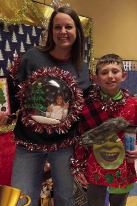 Wellington Elementary School kindergarten teacher Kacy Cabbell and fourth-grader Ben Peters claim the Fourth Annual Ugly Christmas Sweater awards Monday, Dec. 19 prior to school being released for the holidays. Courtesy Photos