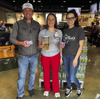 Candice Willis, center, wins HTeaO’s “Free Tea for a Year” giveaway, announced Tuesday, March 14. “Thank you, HTeaO,” Willis said. “I’m thankful and excited.” HTeaO co-owners Vandon Vest, left, and Soni Vest, right, award her with the prize. Photo Courtesy of HTeaO