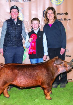 Maverick Orr exhibits the Reserve Breed Champion Dark Other Purebred (OPB) Swine, congratulated by his mom, Marcie Orr, and grandmother Veronica Gray, and purchased by Claude Crisp, Ed LaGrone, Walser Farms/Sunglo Feeds and GO Showpig at the Premium Sale.