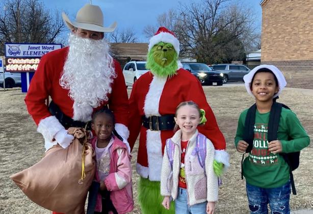 Santa, his helpers and the Grinch visit Childress Elementary