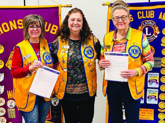 During the Monday, Feb. 17 meeting, Wellington Boss Lion Margret Wood, center, presents Lion Bev Odom, left, with her 15-year service pin, and Lion Sharon Starkey with her 25-year service pin. Courtesy Photo