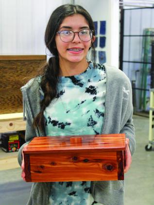 Memphis Middle School eighth-grader Alexis Diaz exhibits her wooden box, as well as a table and chest, at the Memphis Independent School District (ISD) Training Center Showcase Wednesday, May 3.