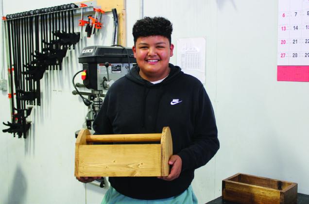 Memphis Middle School eighth-grader Javier Rodriquez shows his wooden toolbox, as well as other projects, at the Memphis Independent School District (ISD) Training Center Showcase Wednesday, May 3. Additional student projects included a flatbed trailer, a steal drum barbecue grill, a tractor seat bar stool, wood racks, metal art, horseshoe sculptures, pipe welds and various woodwork.