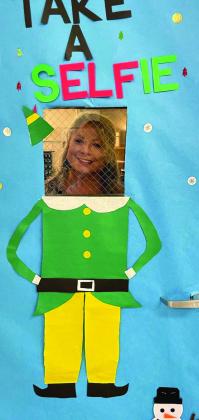 CHS teacher Dawn Jenkins takes a “selfie” with her classroom door.