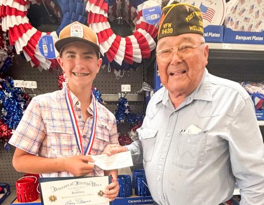 Childress High School freshman Quay Bruce accepts accolades from Wellington Glynn Moore Veterans of Foreign Wars (VFW) Post 6439 Quartermaster Jr. Castillo. Bruce won the Patriot’s Pen essay contest at the Post level, and his essay advanced to the VFW District 9 level that encompasses the Texas Panhandle. Castillo presented Bruce with a $150 award and a certificate. COURTESY PHOTO