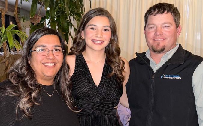 Accompanied by her parents, Lion Amanda and Henry Wiebe, Wellington Lions Club Sweetheart Treylea Wiebe, center, competes in the District 2-T1 Sweetheart Presentation Friday, Jan. 2-Saturday, Jan. 3 in Amarillo.