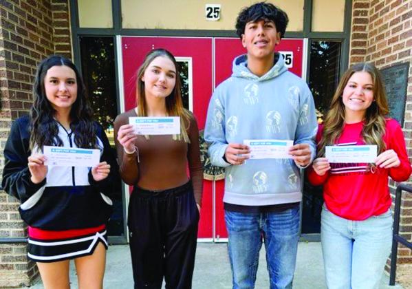 Wellington High School’s Mallory O’Rear, Hadleigh Gurley, Omar Olvera and Currie Forrester accept 10th-round lunch gift certificates, courtesy of Angels Subs &amp;amp; Sweets and Brothers-Sisters of Our Military Adventures, in a recent Friday drawing.