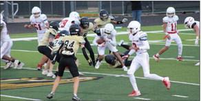 Junior varsity Skyrocket Anthony Ortiz (15) tries to dodge the Falcons in a nail-biting tie game. Others pictured are Nick Nevarez (79), DeMarcus Lewis (3), TJ Salinas (11) and Dixon Dugan (51). The Red River Sun/Shauna Salinas