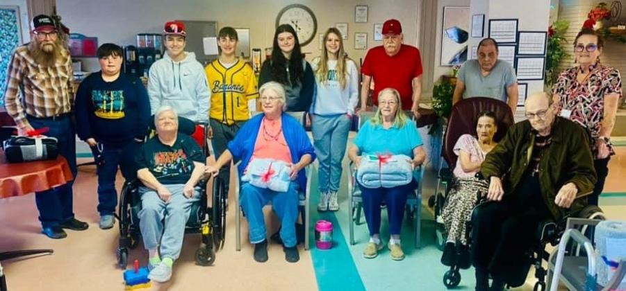 Members of the Wellington Junior High School Student Council Service Committee deliver 40 Operation Blanket Blessing gifts to Wellington Care Center residents Thursday morning, Dec. 21, prior to school dismissal for the Christmas holidays. Students distributing the blankets included Hunter Phipps, Alex Orozco, Lawson Inman, Ansylee Hansen and Anna Needham. Courtesy Photo