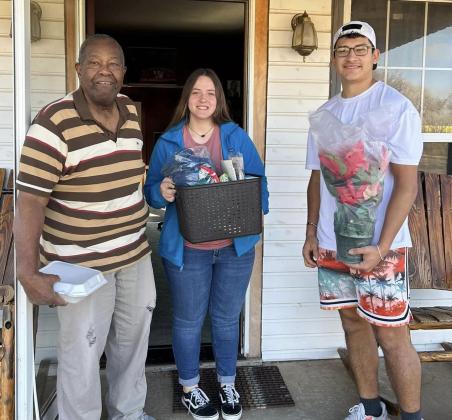 Youth gift Home Delivered Meal clients with Christmas joy
