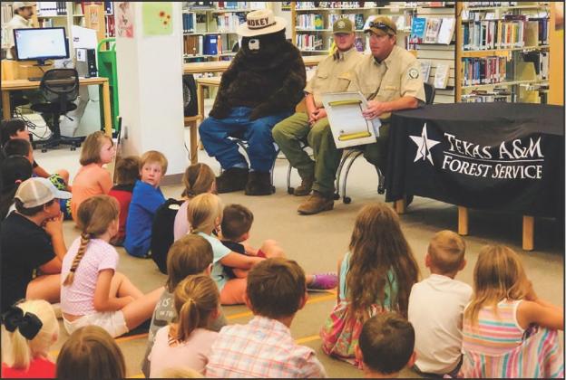 Wellington's Woody Wilson shares the history of Smokey Bear for Monday morning story time at Collingsworth Public Library. Wilson serves with the Texas A&amp;amp;M Forest Service out of Childress. fire prevention and forest fire safety with the students. Families took home brochures