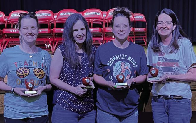 For 10 years of service to Wellington Independent School District, Jordan Conner, left, Karrie Hudson, Kacy Cabbell and Becky Lampe display their Red Apple Clock tokens.