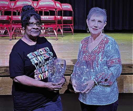 For 35 years of service, Renee Mathis, left, and Vicki Decker accept Crystal Vase mementos.