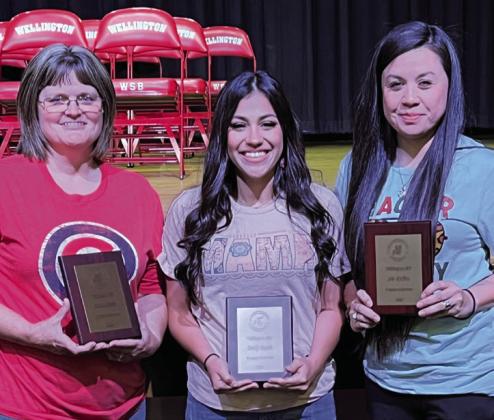 Stacie Smith, left, Emily Rueda and Liz Bodine mark five years of service to Wellington Independent School District with Walnut Plaque awards.