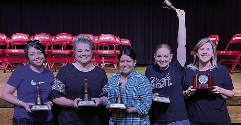 For 25 years of service, Ashley Long, right, receives a Montreux Desk Clock. Meagan O’Rear, left, Denise Stephens, Marcela Estrada and Deidre Kane accept Brass Bell tokens for 15-year service awards.