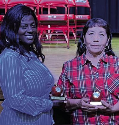 Also for 10 years of service to Wellington Independent School District, Mieshaa Roberson, left, and Maria Jaimes accept Red Apple Clock awards.
