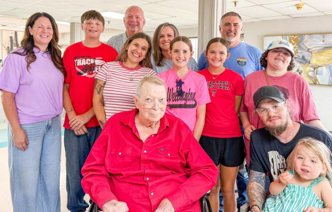 Decked out in his patriotic, Skyrocket-red western shirt, Kent Holland gathers with his family to celebrate an early 80th birthday on Sunday, July 5 at Wellington Care Center. From left: Camie, Carson, Chad and Sarandon Holland; Carly, Blair, Berkeley and Brandon Ward; Taylor, Chase and Margo Holland. COURTESY PHOTO