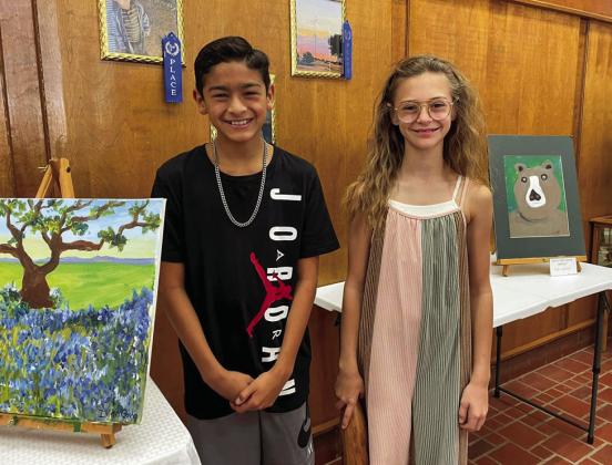 Moore Art Studio students Ivan Garcia, 11, and Selah Smith, 11, display their art at For The Hub of Art Youth Art Show, held Saturday, Sept. 17 at the Childress County Heritage Musuem. Courtesy Photo