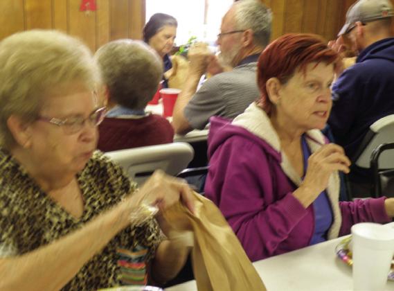 Maxine Skinner, left, and Deloris Trevino were among the 50 seniors who attended the annual Easter Luncheon Thursday, April 6 at the Childress Senior Center. A traditional Easter feast, including ham, chicken and dressing, along with a variety of side dishes, was served. Highlighting the dessert table was an iced white sheet cake adorned with a spring floral motif. The Easter Bunny also gave each guest a brown bag of assorted candies. Photos by Grace Holman