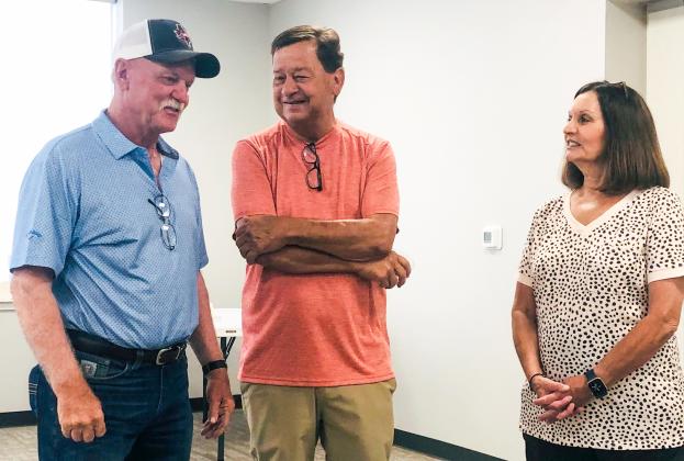 Arnie Ingram visits with guests Carl and Jeanne Taylor, his brother-in-law and sister-in-law, during the recent reception in his honor hosted by the City of Wellington on Friday, June 20, marking his career of over 45 years.