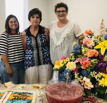 Hosted by the City of Wellington, serving refreshments at the reception in honor of Arnie Ingram are City Secretary Marci Peters, left, Director of Finance Rebecca Pena and Receptionist Dana Langford Hughs. Guests enjoyed berry punch and their choice of two “Veronica” cakes with the script, “Congratulations on Retirement, Happy Retirement, Arnie” and “Thanks for 45 and a Half Years of Service.”