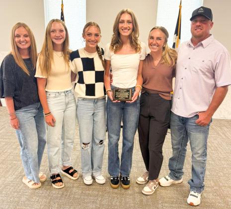 Kyla Kane’s family gathers with her following her induction into the Rocket House Hall of Fame during the Saturday, Aug. 2 Wellington Ex-Student Reunion events in the Club Room of the Bura Handley Community Center. From left: her mother, Deidre Kane; sisters Kaesyn Kane and Taytum Kane; the honoree, Kyla Kane; sister Presley Kane; and her dad, Lance Kane.