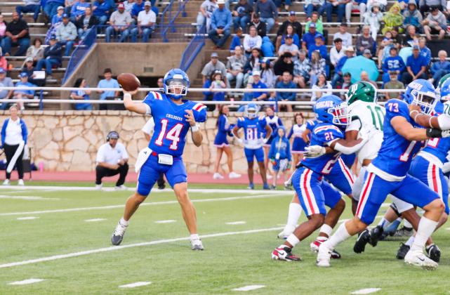 Childress quarterback Koen Galligan looks to make a connection with wide receiver Benton Sims during the Bobcats’ 21-14 win over Breckenridge Friday, Sept. 5 at Fair Park Stadium in Childress.