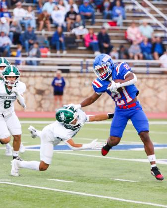 Bobcat running back Lucian Davis picks up yardage for Childress, holding off Breckenridge’s Cooper Wimberley.