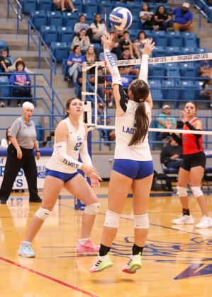 Childress’ Sara Davis sets the ball for middle blocker De’Edra Miller in the Lady Cats’ 3-1 win over the Fort Elliott Lady Cougars Friday, Sept. 5 in Childress.
