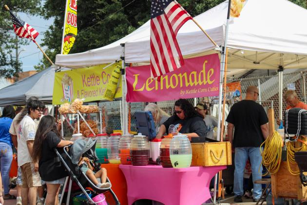 Attendees shop over 40 vendor booths, including Kettle Corn Cuties, during the 90th Annual Hall County Picnic Saturday, Sept. 20 in downtown Memphis.