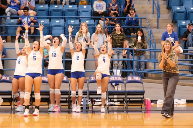 The Childress Lady Cats, including, from left, Addi Edmondson, Sara Davis, De'Edra Miller, Auburn Green and Gloria Garza, as well as Coach Charlsi Bozeman, celebrate.
