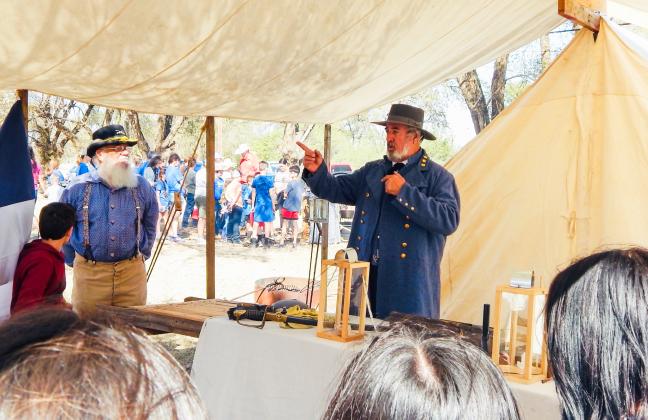 Assisted by organizer Darrell Colson, Steven Boone, reenacting Confederate General Robert E. Lee, explains life during the American Civil War to area students during the 2024 Living History Weekend at Powell Park in Wellington. Hosted by the Sons of Confederate Veterans Charles Goodnight Frontier Reg. Camp #2280, the 2025 event will again take place Friday-Saturday, Oct. 3-4 at Wellington’s Powell Park on Hwy 83.