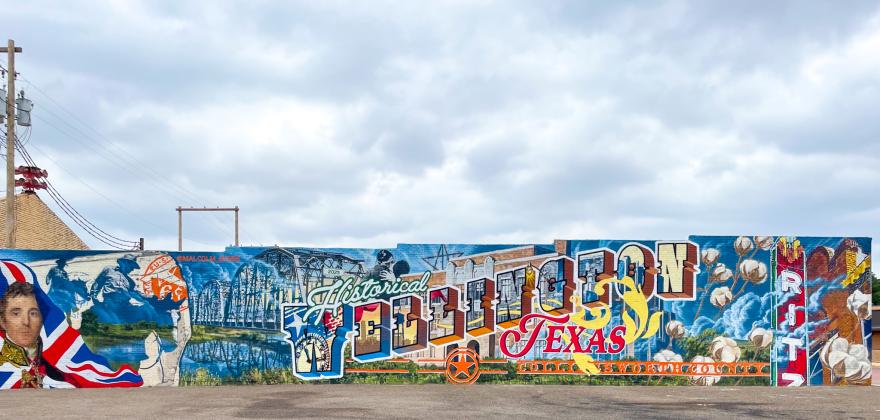 Commissioned by the Wellington Community Fund, depicting Collingsworth County and Wellington history, muralist Malcolm Byers presents his final mural design, finishing the last spray paint stroke around 12:30 p.m. Friday, Sept. 5 at 915 West Ave.