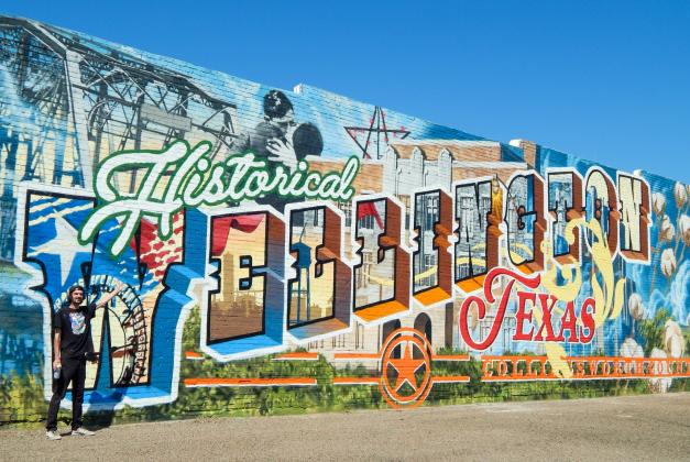 Renowned muralist Malcolm Byers, a native of the Amarillo area, stages himself in front of the clock tower of his massive masterpiece Wednesday afternoon, Sept. 3.