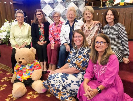Bazaar Bear gathers with the Wellington Methodist Women for a preview of the 2025 quilt during a recent Sunday morning worship service. The quilt raffle will take place at 1 p.m. Saturday, Nov. 1 during the Methodist Women’s Fall Bazaar. Front row, from left: Kelly Bawcom, Karen Caldwell. Second row, from left: Sharon Starkey, Deltah Henard, Fran Eigenman, Leslie Schnaufer, Charlotte Stephens, Nancy Henard.