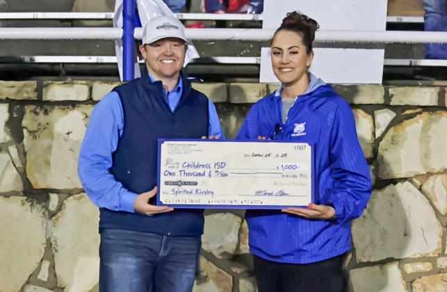 First United Bank Assistant Vice President and Childress Branch Manager Alabama Bohannon presents Childress High School Principal Keely Hackler with a check totaling $1,000 Friday, Oct. 24 at Fair Park Stadium in Childress.