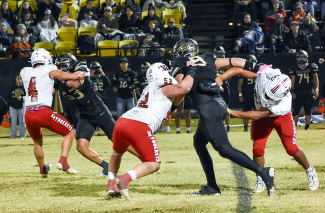 Fighting for the district championship title, Wellington’s Noah Cantu (4), Hunter Hedrick (52) and Elijah Granados (67) slow down the Wheeler Mustang offense for a Friday night, Oct. 31, where the Skyrockets fell 12-0 on the road.