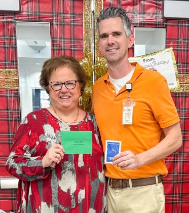 Collingsworth General Hospital Administrator Candy Powell, left, presents Kenny Keys his 10-year service award.