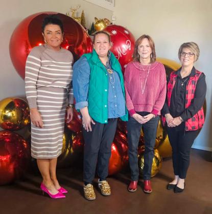 Host Brooke Carter, left, with Hearts United Give Support (HUGS) volunteers Whitney Wiebe, Marcy Sessions and Donnie Carter, welcome visitors for the Holiday Home Tour on Sunday afternoon, Dec. 7.
