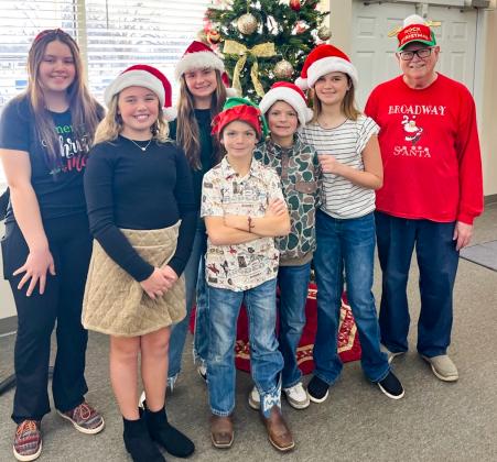 Monson Music Studio students entertain residents at Parkview Manor Assisted Living and Wellington Care Center with 20 Christmas carols Saturday, Dec. 20. From left: Ava Barlow, of Quail, piano, ukulele and vocals; Rafe Barlow, of Wellington, piano; Grace Peters, of Wellington, piano; Ezra Peters, of Wellington, piano; Caleb Peters, of Wellington, piano; Chelsea Harms, of Wellington, violin and vocals; and Monson Music Studio owner and instructor Gerald Monson, of Childress.