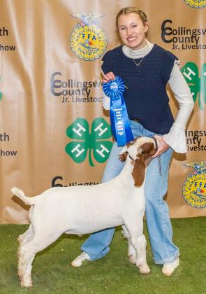 Elli Ouellette shows the First Place Class 1 Goat, purchased by Souder Farms at the Premium Sale.