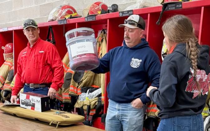Announced by Matt Wynn, Matt Orr holds each ticket donation bucket while Brylnn Kemp draws the winners.