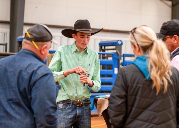 Childress’ Tripp Tippett shows judges his Division 2 Reserve Champion-winning spurs during the Ag Mechanics portion of the Childress County Youth Project Show Saturday, Jan. 10 at the Mashburn Event Center and Arena.