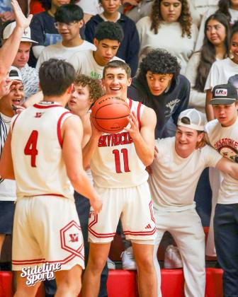Wellington fans cheer on the Skyrockets in the Friday, Jan. 9 matchup versus Panhandle as junior Callen Kane (11) passes the ball to senior Noah Cantu (4). The Panthers took the 60-48 win.