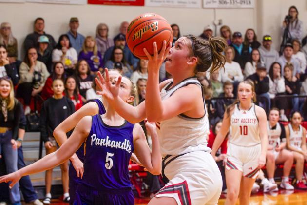 Lady Rocket Ceighley Killian (11) goes up for the shot, with Bryn Phillips (10) close at hand for the rebound, in Wellington’s close 34-26 loss to the Pantherettes on Tuesday, Feb. 3 in Panhandle.